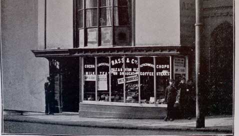 The shop window of the Murenger House advertises   coffee and cocoa, steaks and chops